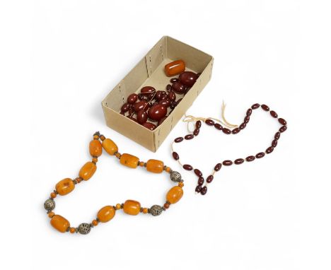 A single strand amber bead necklace, with filigree metal spacers, 48cm, gross 84 grams, together with a group of loose gradua