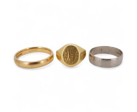 A 1990's 18ct gold wedding band, with engraved inscription, size U/V, a similar signet ring with engraved monogram and inscri