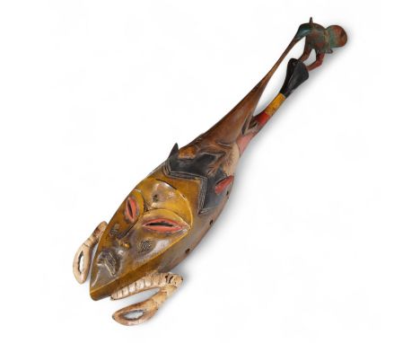 An early 20th century Tribal carved and painted mask from the Ivory Coast, 74cm in length