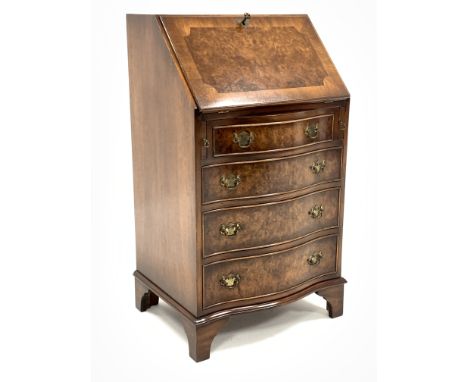 Reprodux figured walnut serpentine bureau, the crossbanded fall front revealing interior fitted with cubby holes and tooled l