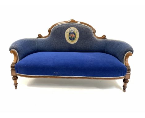 Victorian mahogany framed three seat sofa, scrolled serpentine cresting rail over swept arms, covered in blue fabric with a c