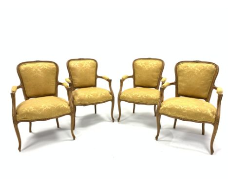 Set four French beech open armchairs, the exposed moulded frame decorated with floral carvings, arm rests, seat and back pane