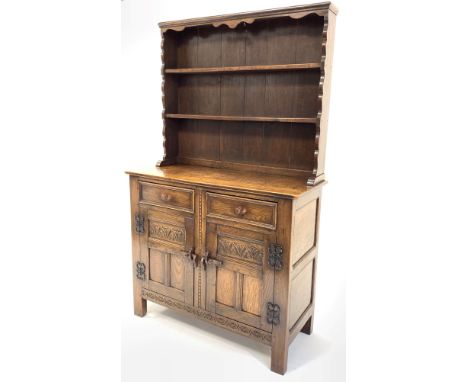 18th century style medium oak dresser, with two height plate rack over two drawers and two lunette carved panelled cupboards 