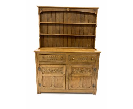 20th century light oak dresser, two height plate rack carved with Yorkshire rose roundels over two drawers and two panelled c