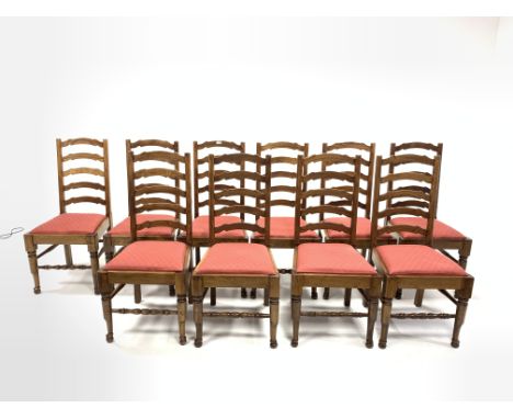 Set of twelve oak waved ladder back dining chairs with drop in upholstered seat pads and turned front supports and stretchers