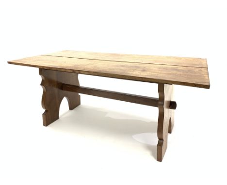 Early 20th century hardwood refectory style table, the rectangular top raised on shaped panel end supports united by pegged s