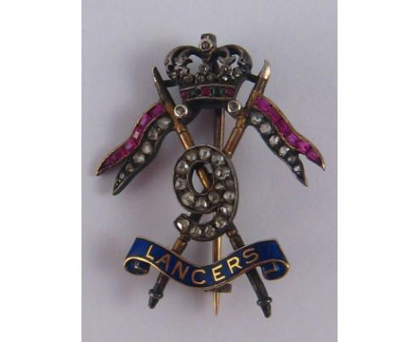 Militaria. A late 19th - early 20th century gold, silver, diamond, ruby, emerald and enamel regimental badge of the 9th Queen