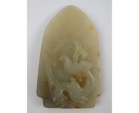 A green jade pendant carved with a mythical beast. 8cm. 