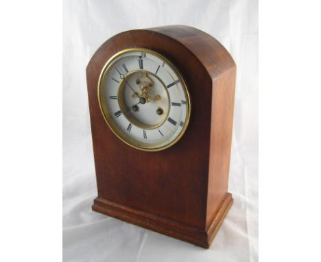 A domed top oak cased eight day mantel clock with visible escapement and bell striking. Ht.33cm. 