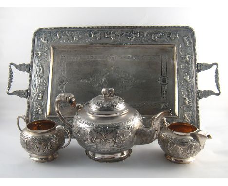 An Indian three piece silver teaset and tray, the teapot with elephant head and trunk spout and elephant finial, all three pi