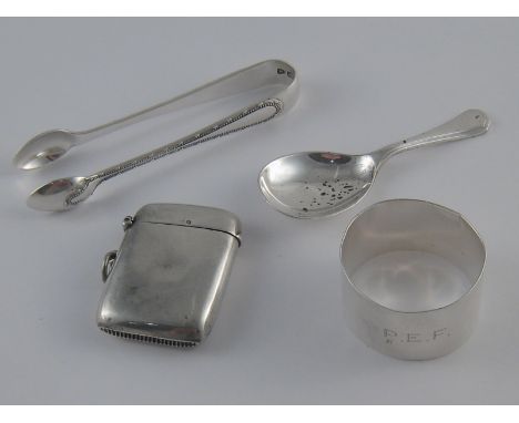 Silver. A vesta, Birmingham, 1917, a caddy spoon, Francis Higgins, London, 1977, pair of tongs, London 1895, and a napkin rin