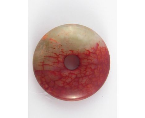 A red and light green polished Bi, 4.5cm. diameter. 