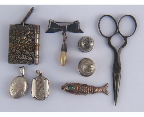 Two silver thimbles, a chatelaine book form pincushion and a pair of steel scissors, together with two silver lockets, a silv