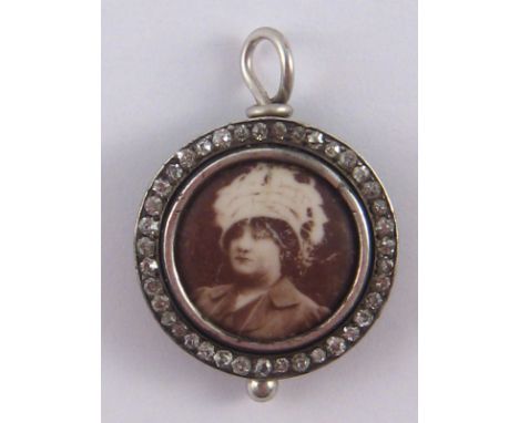 An antique silver and diamond miniature portrait pendant, approx 2cm.
