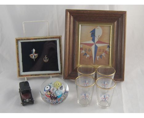 Festival of Britain memorabilia. A multi cane paperweight, one cane "London 1951", an enamel badge and enamel pendant in glaz