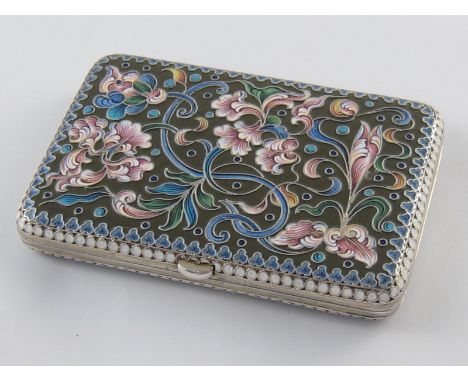 A Russian silver gilt cigarette case decorated with scrolling floral shaded cloisonne enamels against a brown enamel ground. 