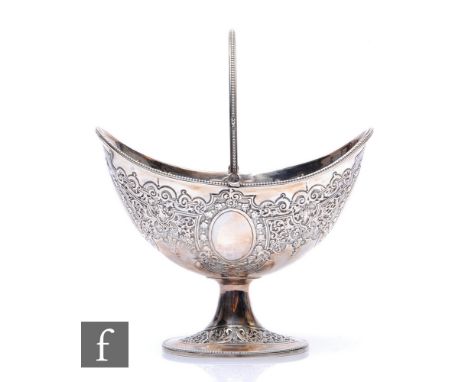 A Victorian hallmarked silver boat shaped pedestal sugar basin with foliate embossed decoration within beaded borders, weight