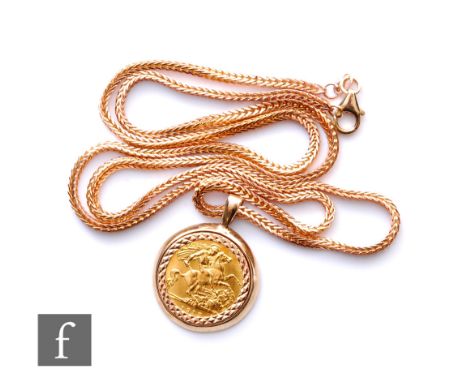 A George V half sovereign loose mounted to a 9ct pendant mount and suspended from a 9ct foxtail link chain, total weight 20.5