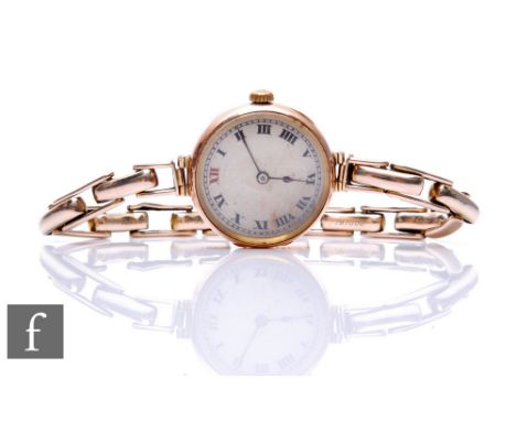 A 9ct hallmarked Rolex manual wind wrist watch, Roman numerals to a silvered circular dial, case diameter 26mm, to a 9ct expa