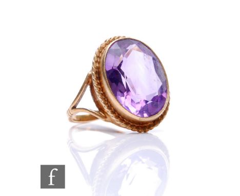 A 9ct hallmarked single stone amethyst ring, oval collar set stone to a rope twist border, weight 4.7g, ring size K. 