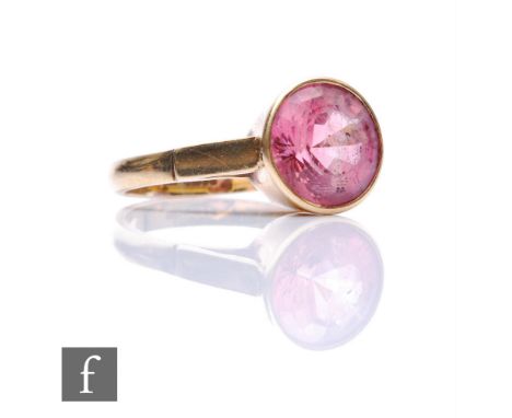 A 9ct hallmarked single pink stone dress ring, high collar set circular stone to bridge shoulders, weight 4.6g, ring size T. 