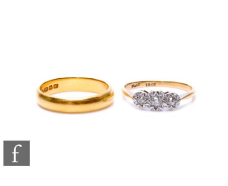 A 22ct hallmarked wedding ring, weight 4.3g, with an 18ct illusion set diamond three stone ring, weight 2.1g. (2) 