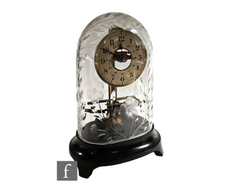 An early 20th Century Bulle lacquered brass electric mantel clock with silvered chapter ring, beneath a floral patterned cut 