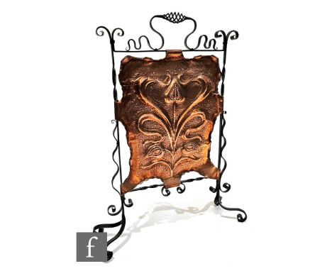 An Art Nouveau copper firescreen, the central panel detailed with a repousse work stylised seed pod within a scroll work wrou