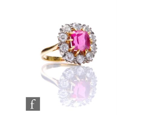 AMENDED DESCRIPTION An 18ct paste and diamond cluster ring, central cushioned square ruby, length 7.5mm, within a border of t