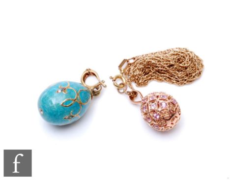 A 9ct egg shaped pendant pierced and set with pink sapphires and suspended from a 9ct trace chain, total weight 5.8g, with a 