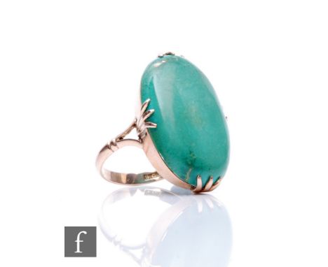 A 9ct single stone oval turquoise ring, claw set stone, length 30mm, to split shoulders, weight 7.4g, ring size P. 