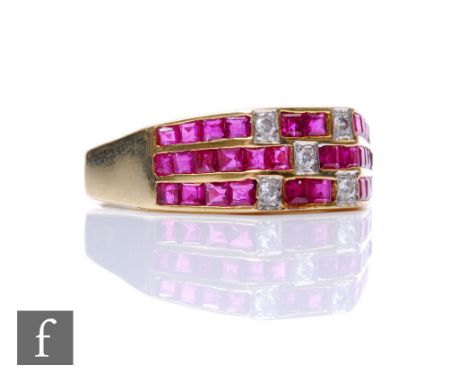 A 14ct ruby and diamond ring comprising three horizontal rows of channel set square cut rubies detailed with five diamonds, w