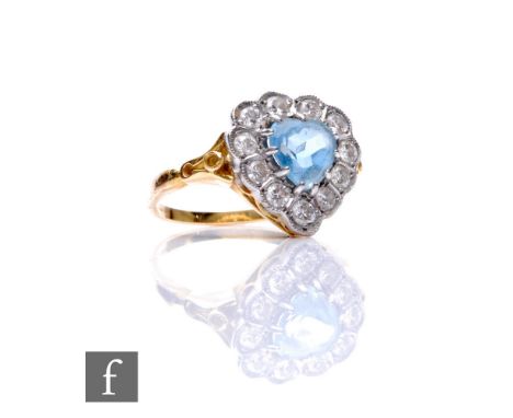 An 18ct aquamarine and diamond cluster ring, heart shaped cut aquamarine within a border of eleven brilliant cut diamonds, le