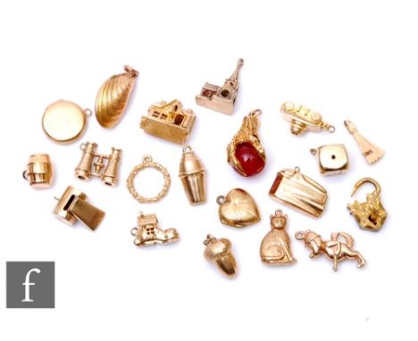 Eighteen assorted 9ct charms to include a church, binoculars and a camera, total weight 33.5g, with a 9ct claw and ball and a
