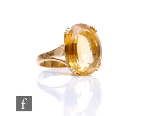 An 18ct single stone yellow beryl ring, oval claw set stone, length 16mm, weight 6g, ring size N. 