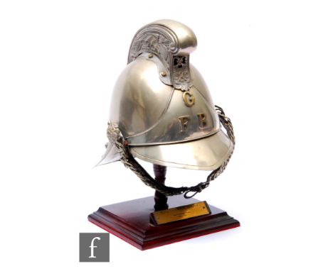 An early 20th Century plated Fire Officer's helmet, Merry Weather pattern for the Gloucester Fire Brigade, scroll comb over G