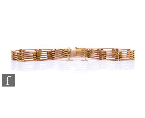 An early 20th Century 15ct five bar flexible gate bracelet, weight 19g, terminating in tongue and box fastener, stamped 15 to
