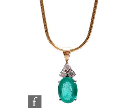 A 14ct emerald and diamond pendant with oval claw set emerald, length 8mm, below three brilliant cut diamonds, all suspended 