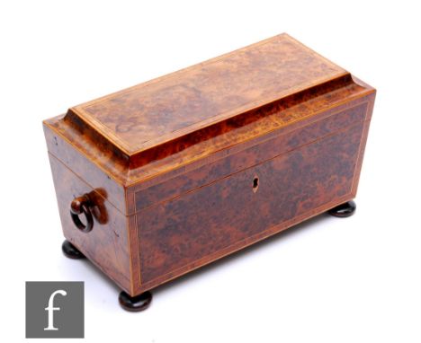 A 19th Century crossbanded birds eye maple tea caddy of sarcophagus form, fitted with two canisters but lacking mixing bowl, 