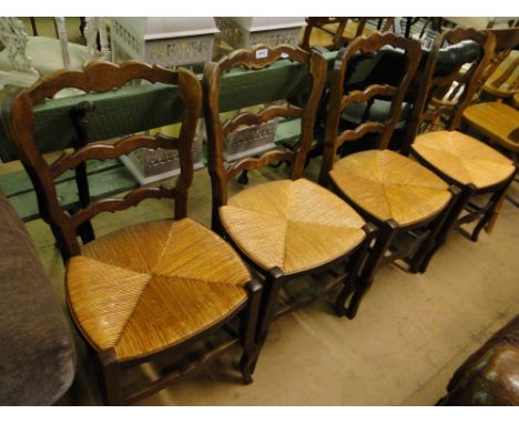 A set of 4 French oak ladder back rush seated dining chairs.