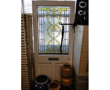 A painted external door with coloured lead light glazed panel, door height 2 metres x 83cm approx.