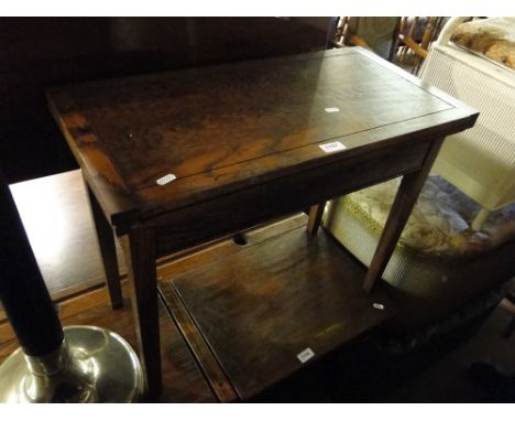 A small oak foldover card table.