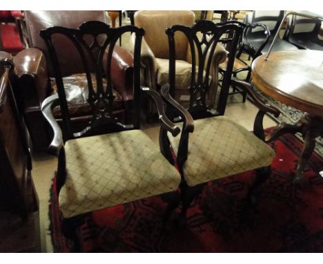 A pair of Chippendale design mahogany elbow chairs with pierced splat backs.