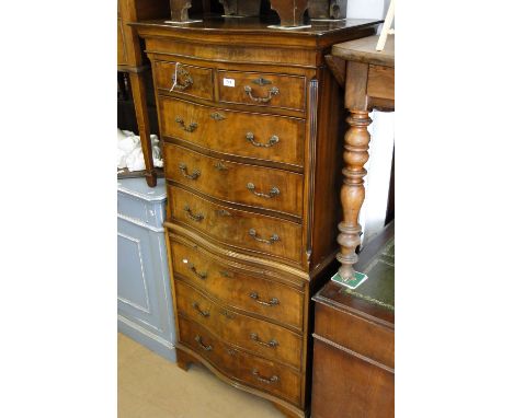 A Reproduction crossbanded mahogany chest-on-chest of serpentine form, on bracket feet