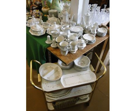 An extensive service of Johnsons "Eternal Beau" dinner, tea & coffee ware, including tureens, a tea trolley, serving plates, 