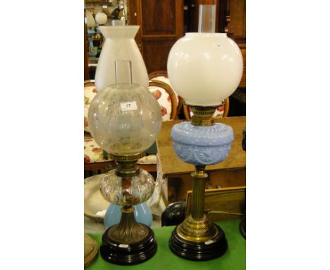 An Edwardian glass oil lamp with shade, & a brass oil lamp with milk glass font & shade