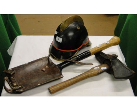 Antique fireman's helmet & axe, & a German military trench shovel