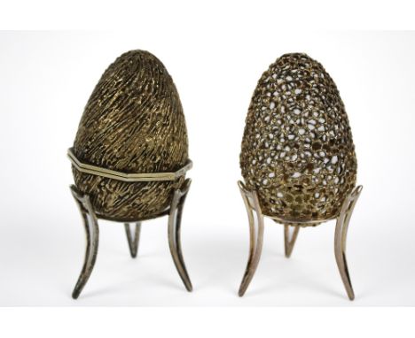 Two silver gilt surprise eggs, marked London 1971 and 1975, together with two silver stands London 1978, all Markers mark for