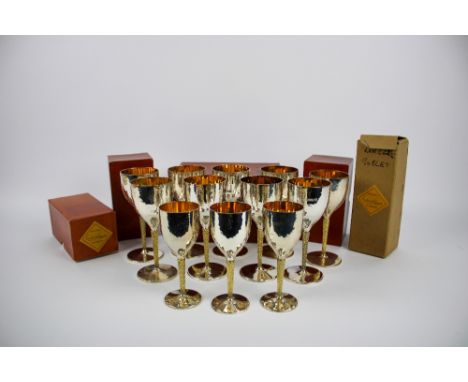 Nine silver and silver gilt wine goblets and three  desert wine goblets, all marked London , eleven 1977 and one 1975, Marker