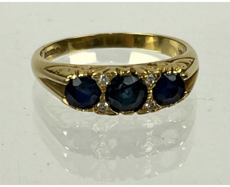18 Carat Gold Sapphire and Diamond half-hoop Ring, set with circular sapphires and brilliant-cut diamonds, British hallmarks 